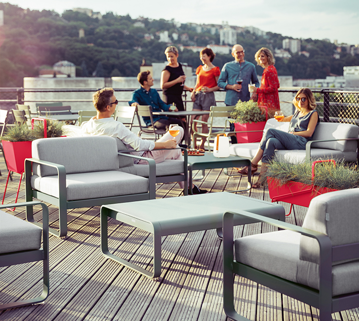 Große Terrasse mit Loungemöbeln und Menschen
